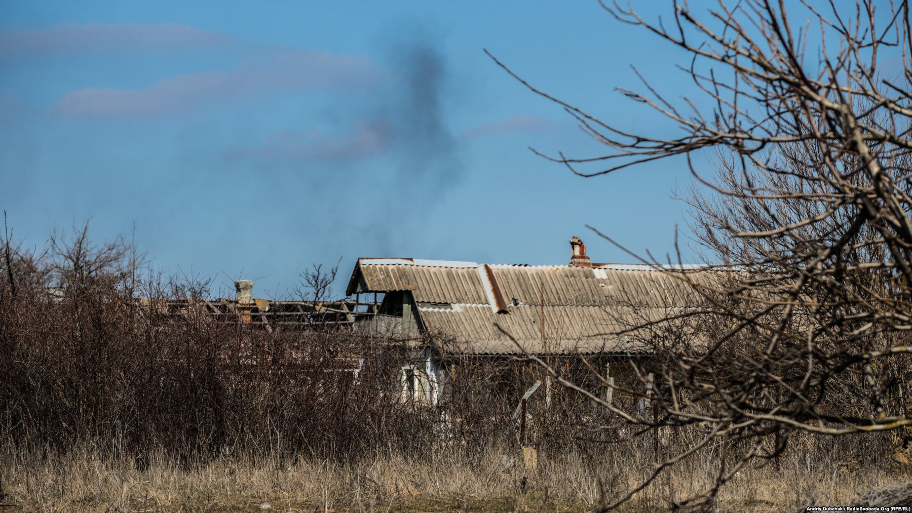 As RFE/RL photojournalist Andriy Dubchak walked through Vodyane on March 26, a series of explosions, followed by an intense burst of shooting broke out on the outskirts of the village. As Dubchak watched, this column of smoke drifted into the sky. 