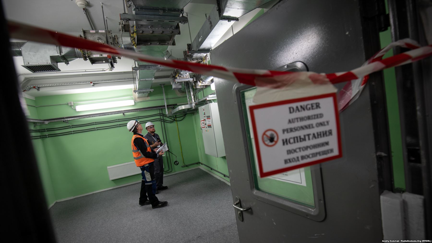 Workers at Chernobyl's New Safe Confinement (NSC) inspect new equipment. Two years after the structure was put into position, containment systems are still being installed and tested. The cost of the shield was almost $1.6 billion, with funding coming from the European Bank for Reconstruction and Development. Photo by: Andriy Dubchak