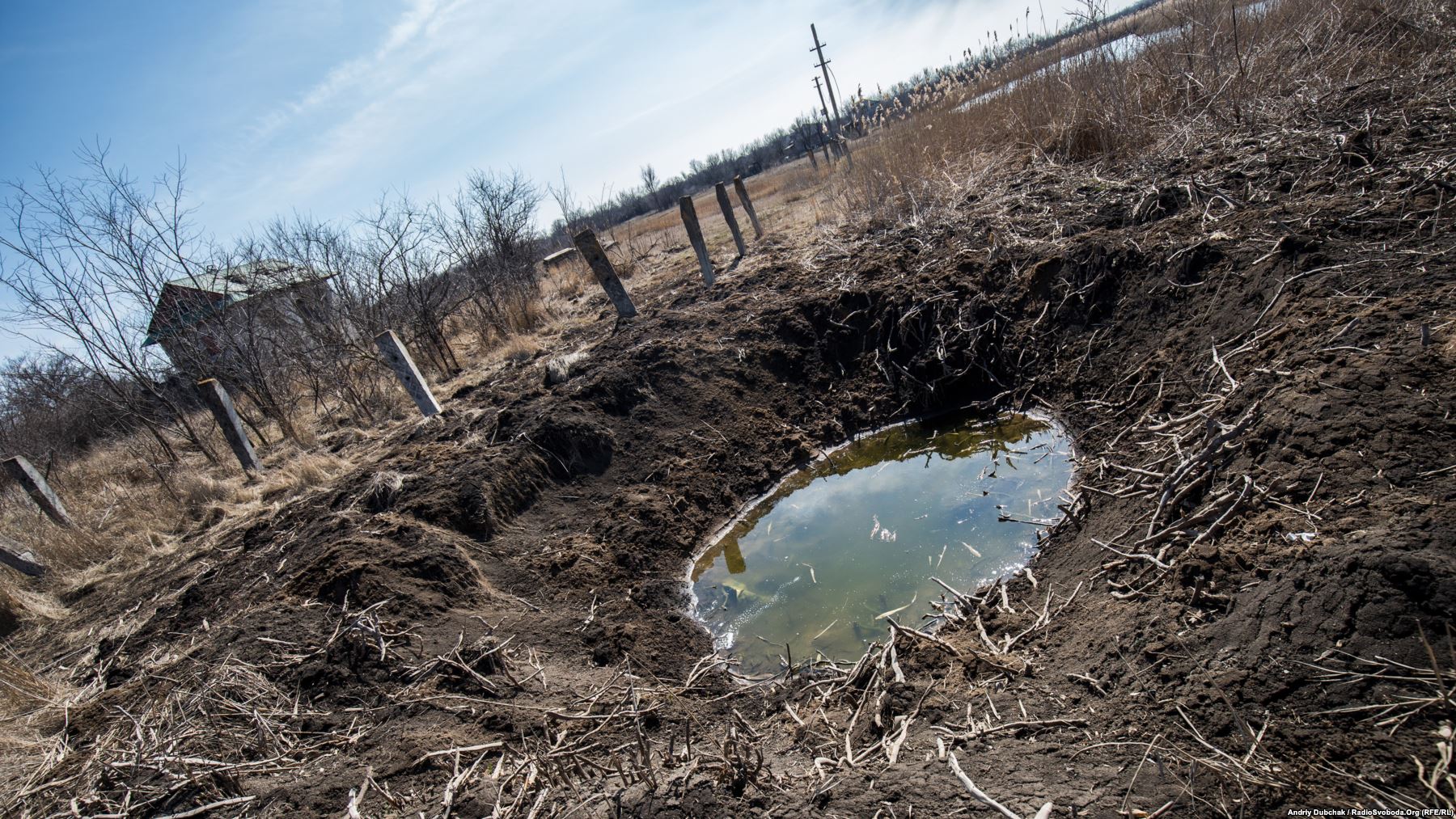 A crater left by the shell of a 152-mm field gun. Photo by: Andriy Dubchak