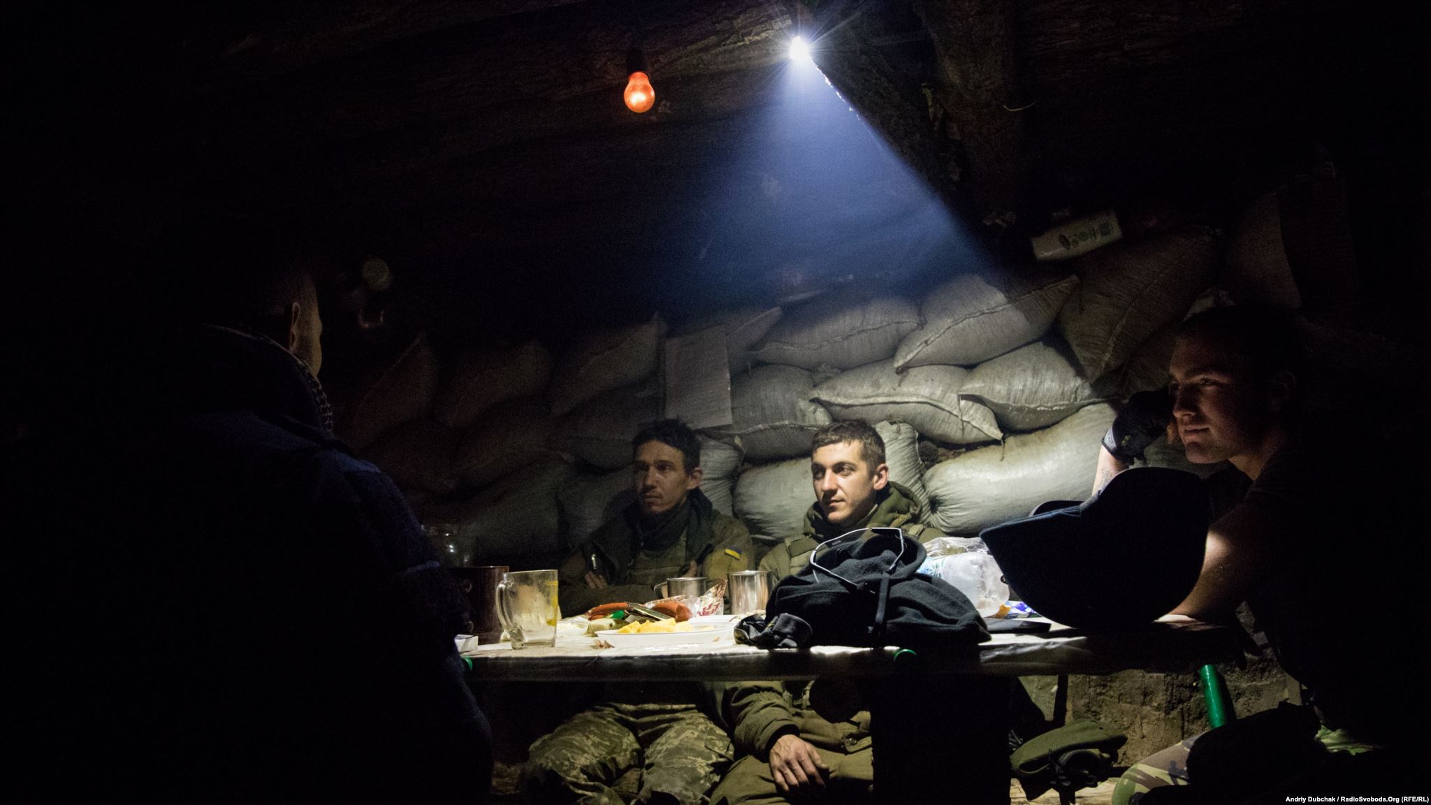 Dinner in the middle of fighting. Men drink tea and rest in a kitchen-dugout, while other soldiers were suppressing enemy fire. (photo by ukrainian military photographer Andriy Dubchak)