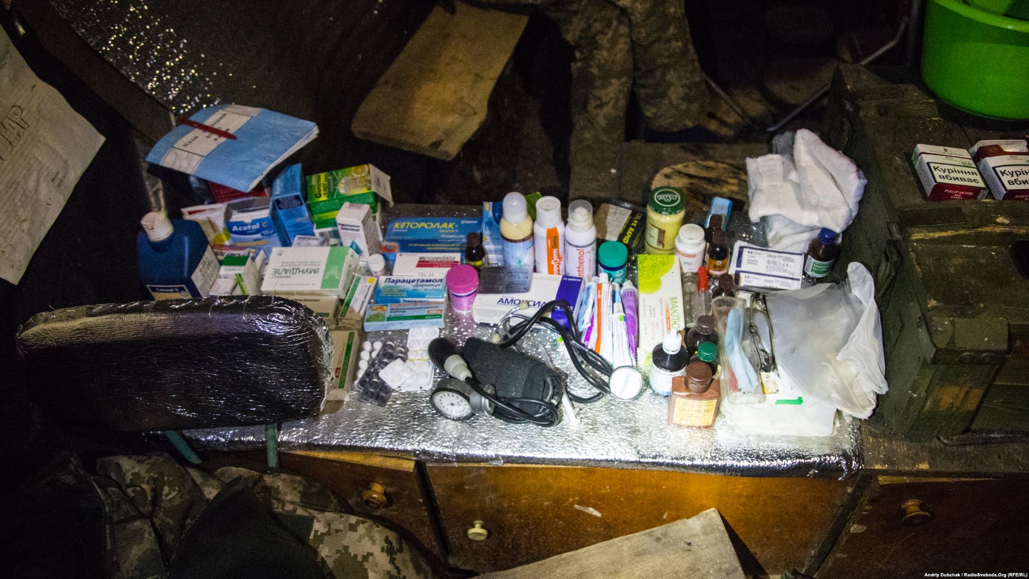 Medical supplies in a dugout-kitchen-sleeping room. Here is pretty much everything that needed - common cold-flu medicines and special medications for treating serious combat injuries (photo by ukrainian military photographer Andriy Dubchak)