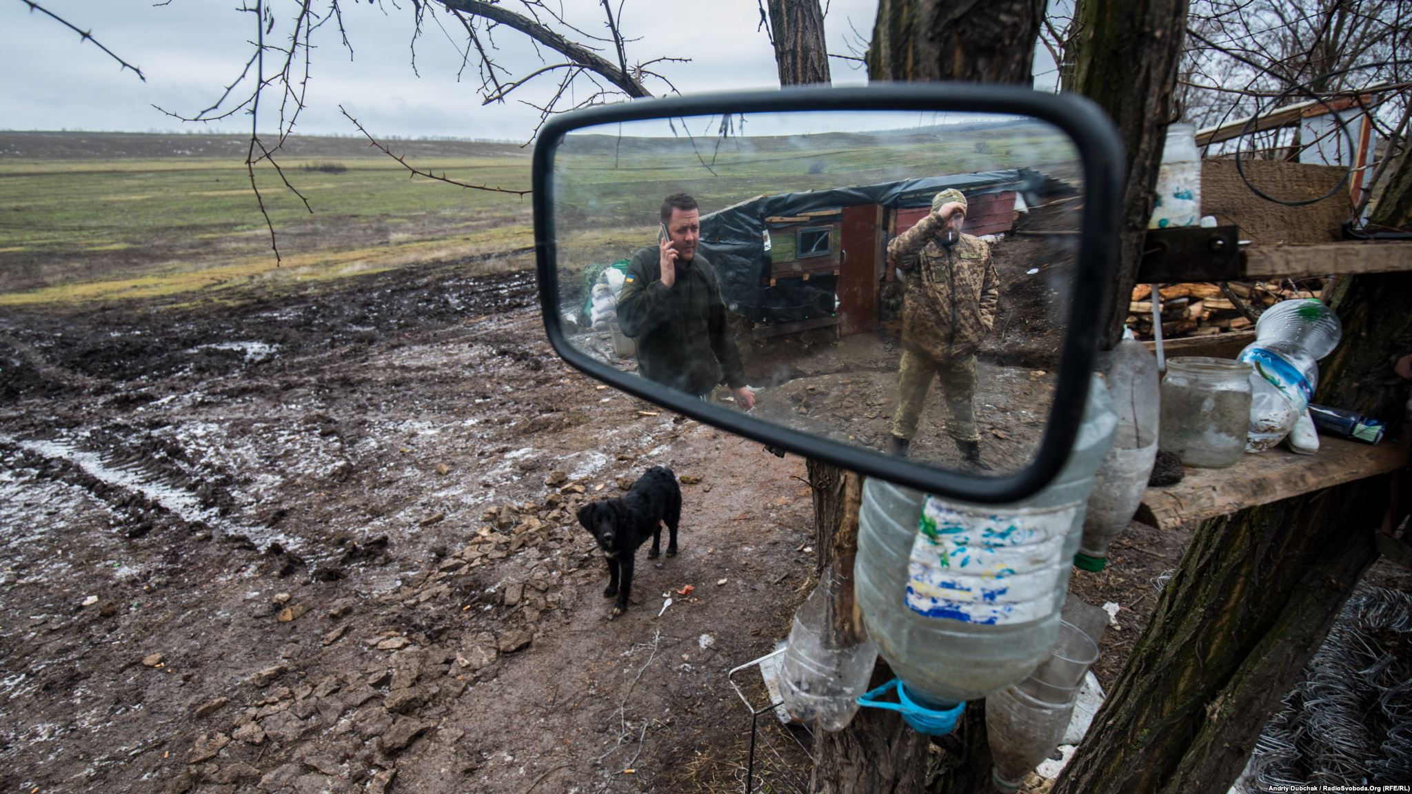 Puppy on position. Mirror and inverted bottles form a summer washstand. (photo by ukrainian military photographer Andriy Dubchak)