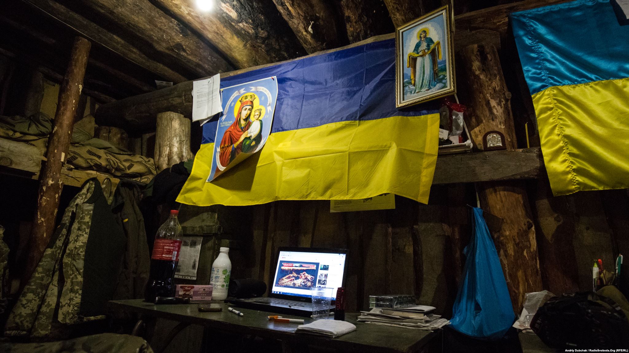 Icons and flags in a living dugout. (photo by ukrainian military photographer Andriy Dubchak)