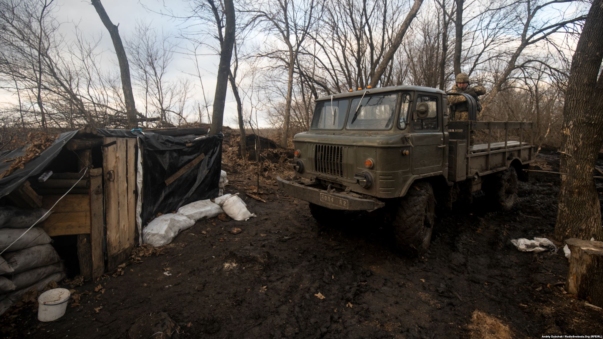 Entrance to a dugout and “shishiga” car (photo by ukrainian military photographer Andriy Dubchak)