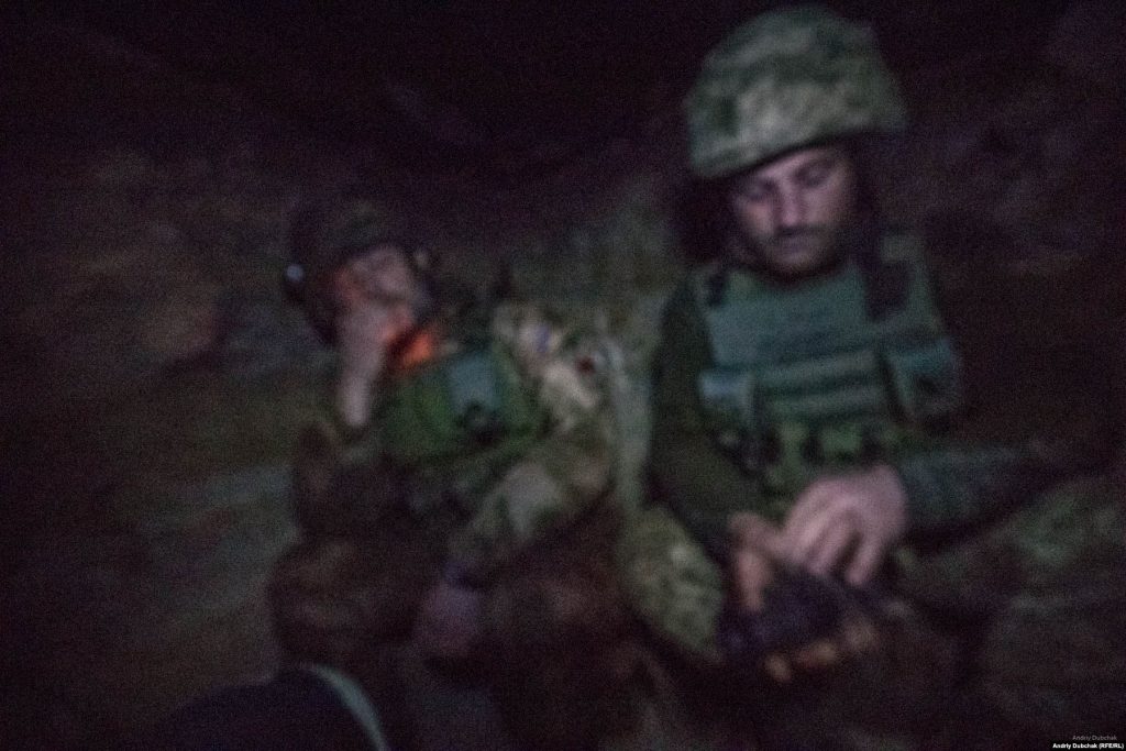 In the darkness of a dugout near Bakhmut in December 2017. Photo: Andriy Dubchak