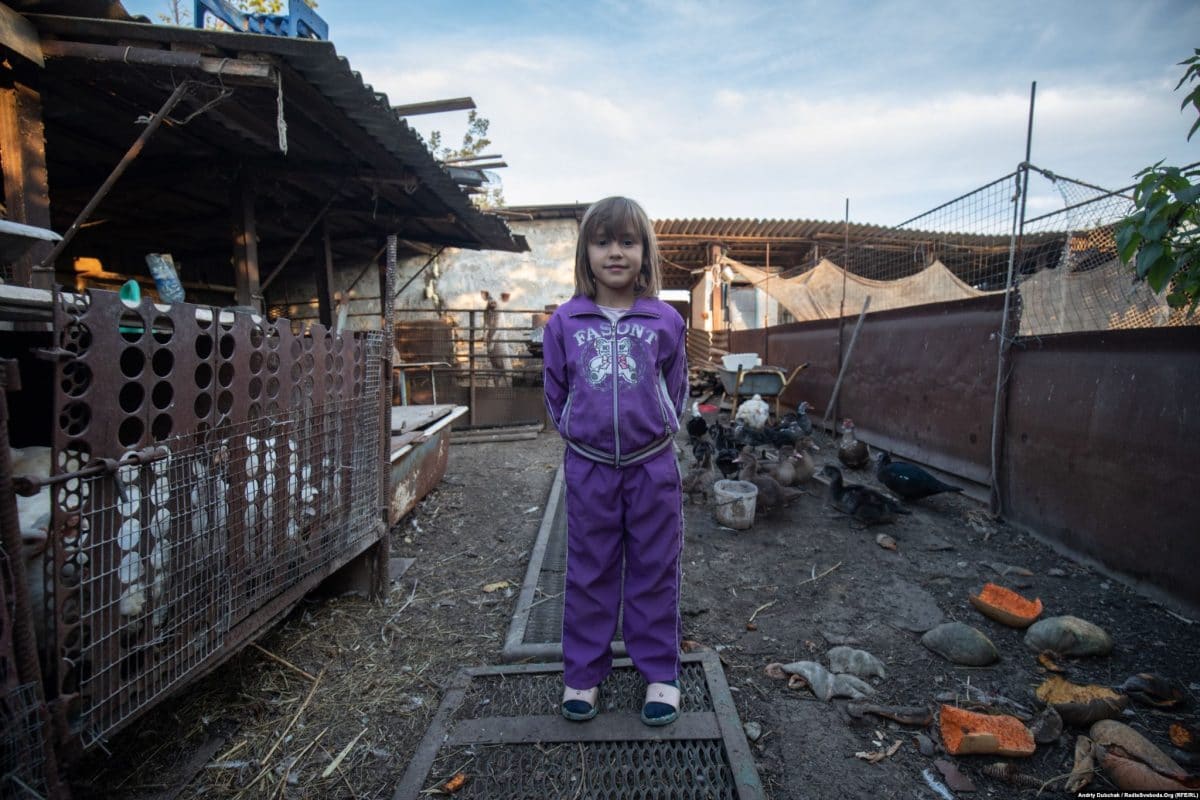 Sabrina, 7, on her family's farm in Pavlopil (photo: Andriy Dubchak)