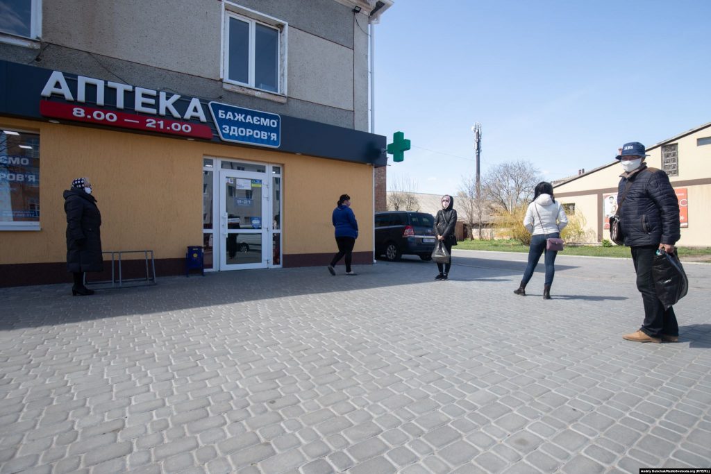 Locals keep their distance as they wait in line outside a pharmacy. One resident of Kalynivka said the town’s elderly residents initially poked fun at people wearing face masks "then, as the situation developed, everyone quickly adopted [the masks]." Photographer Andriy Dubchak / Ukraine